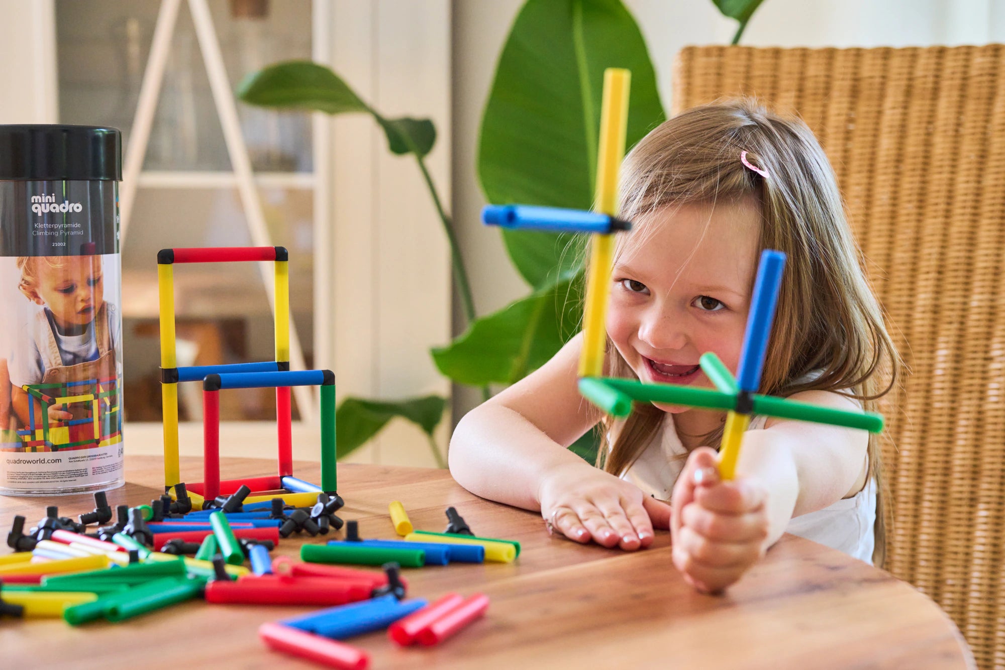Girl holding up her colourful QUADROmini model