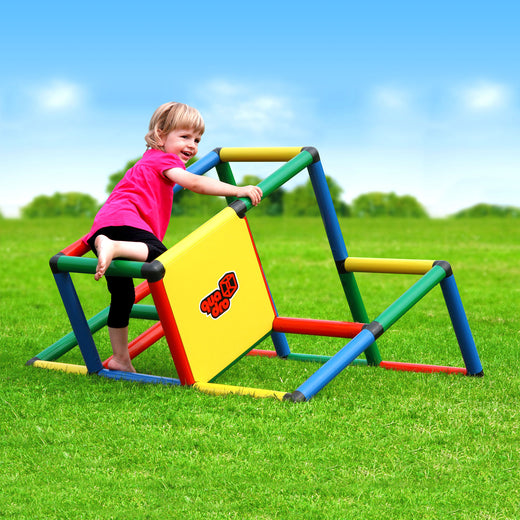 Barefoot child climbing on My First QUADRO Classic with yellow panel in the garden