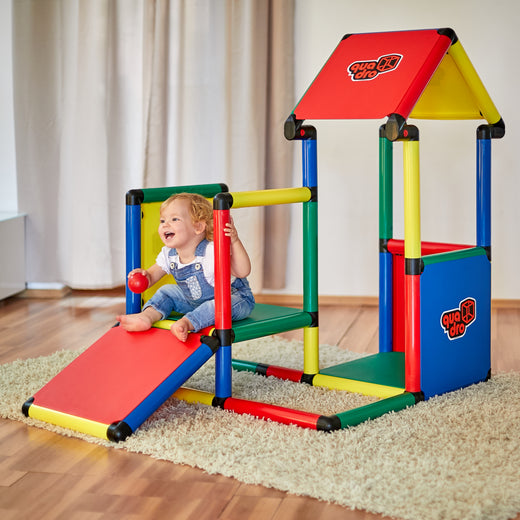 Toddler on QUADRO Adventure Classic with ramp and covered play tower