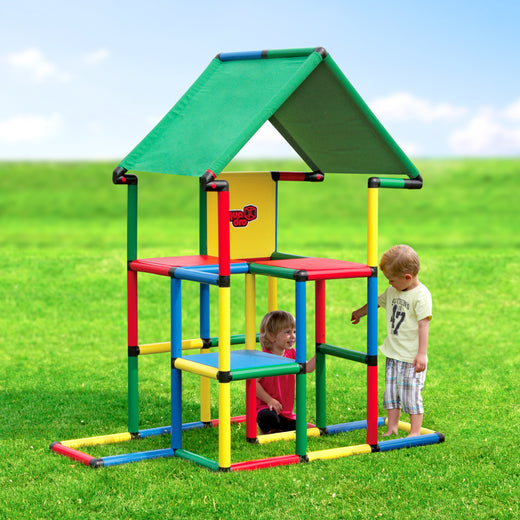 Two children playing in the garden on QUADRO Junior Classic with two-story play tower and green roof textile